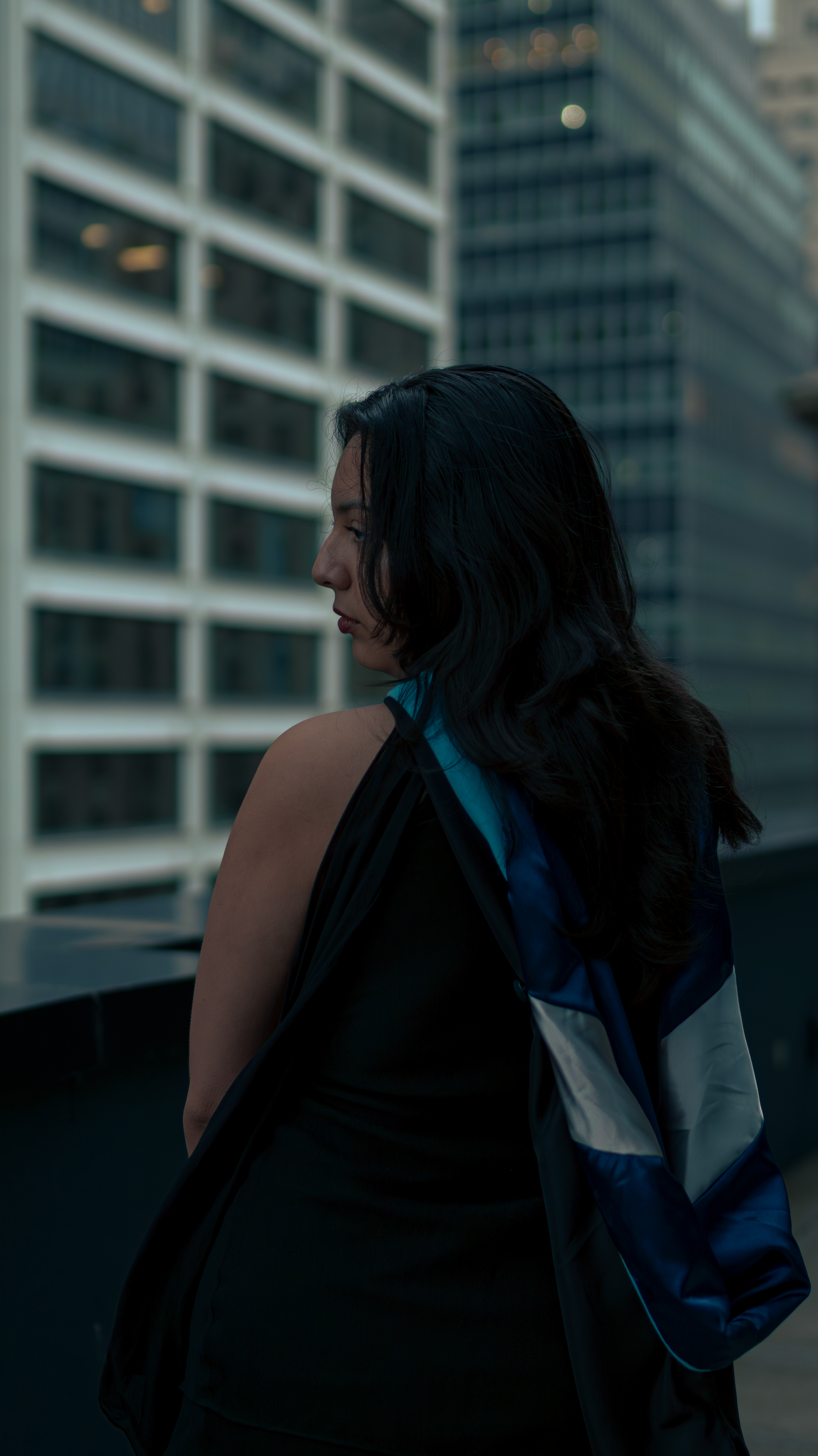 Woman in cap and gown in the city
