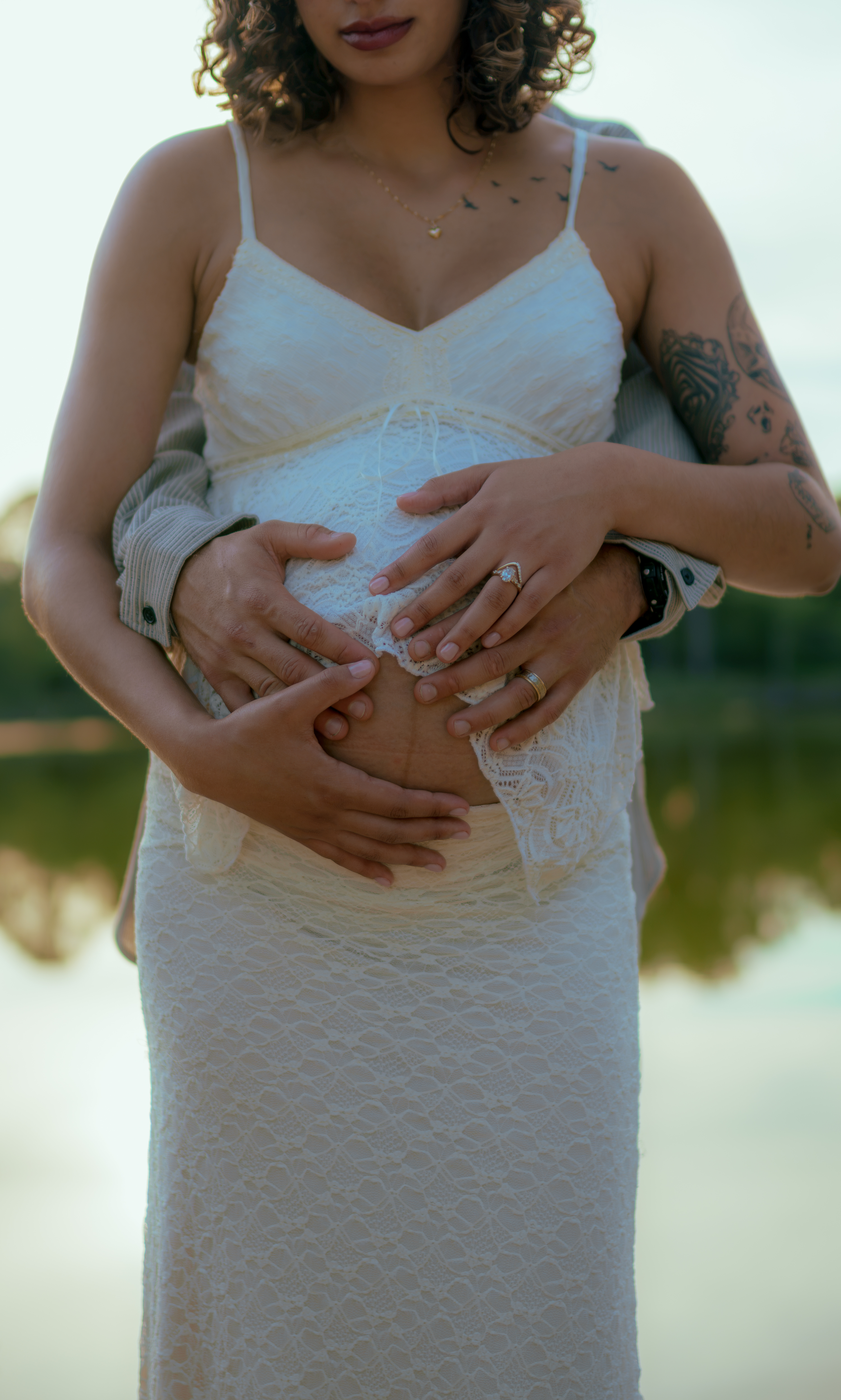 Pregnant woman embraced by her husband