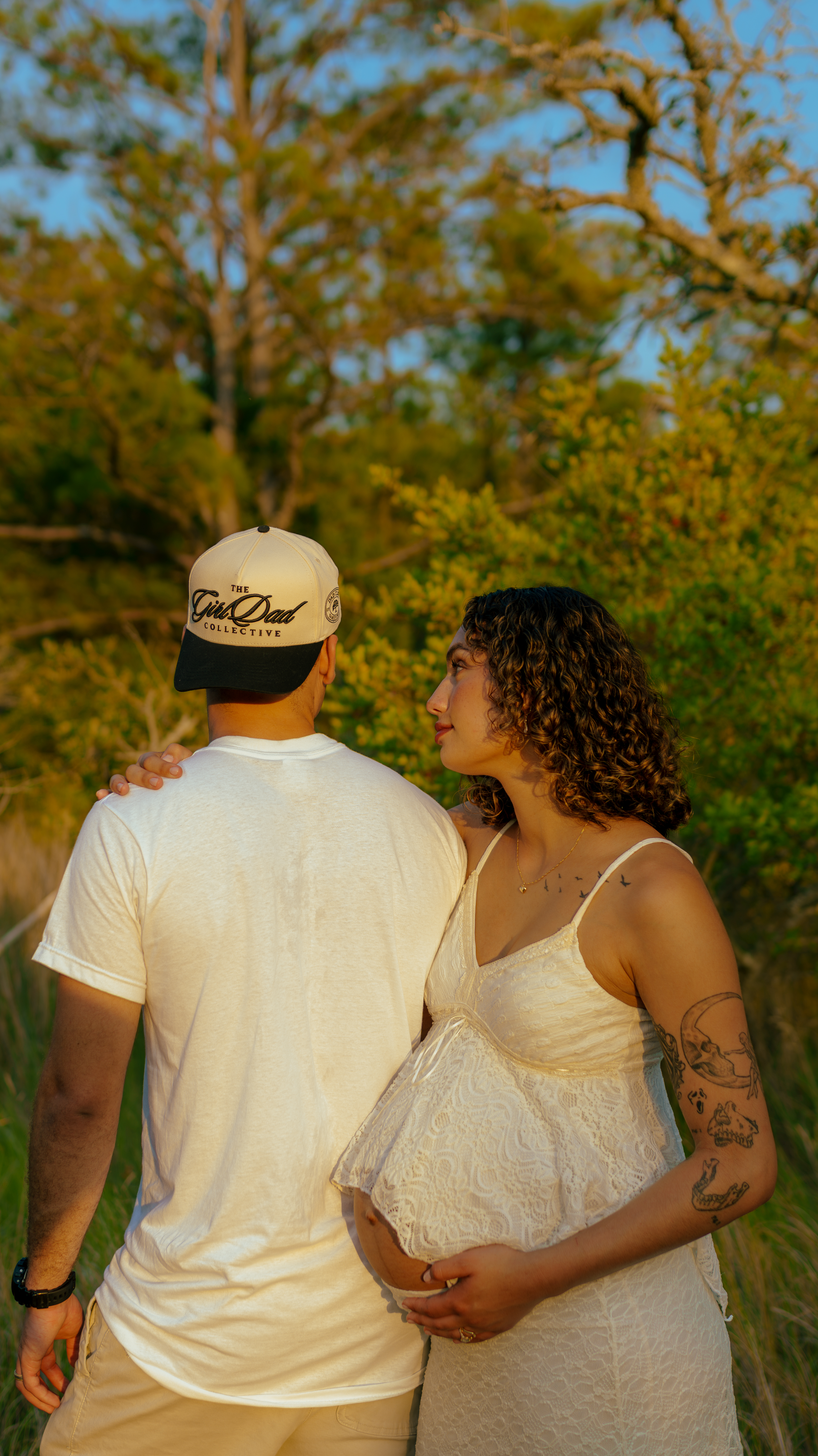 pregnant woman and husband in the woods